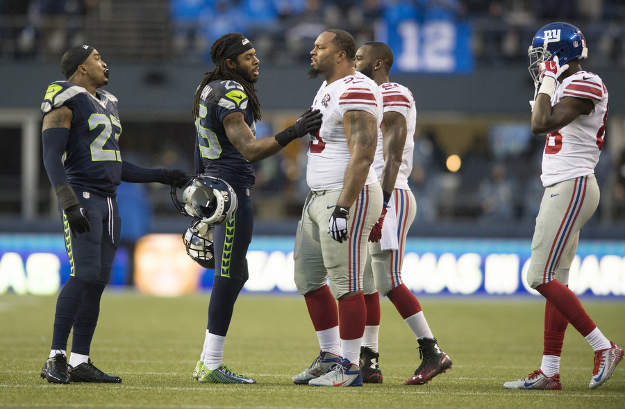 Seahawks cornerback Richard Sherman tries to calm down Giants defensive lineman Cullen Jenkins, who was upset with Seahawks safety Jeron Johnson for a hard hit on Sunday, Nov. 9, 2014 at CenturyLink Field.